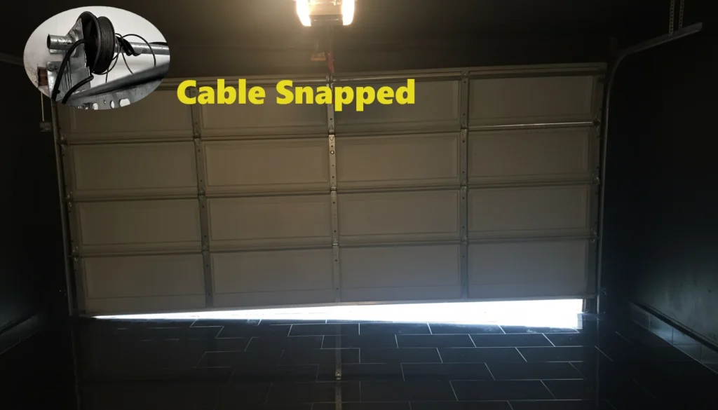 A crooked garage door with a visible floor gap on one side caused by a snapped lift cable.